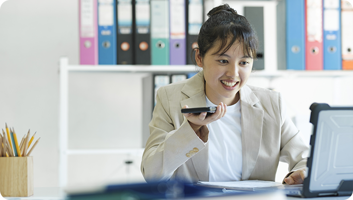 A healthcare credentialing specialist managing provider enrollment and Medicare applications on a laptop in an office.