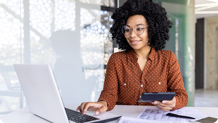 A medical billing auditor analyzing claims accuracy and financial reports on a laptop for a hospice and home health agency.